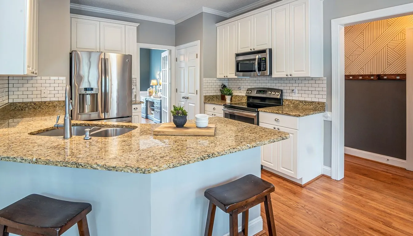 Kitchen with a microwave mounted above the range and a granite island