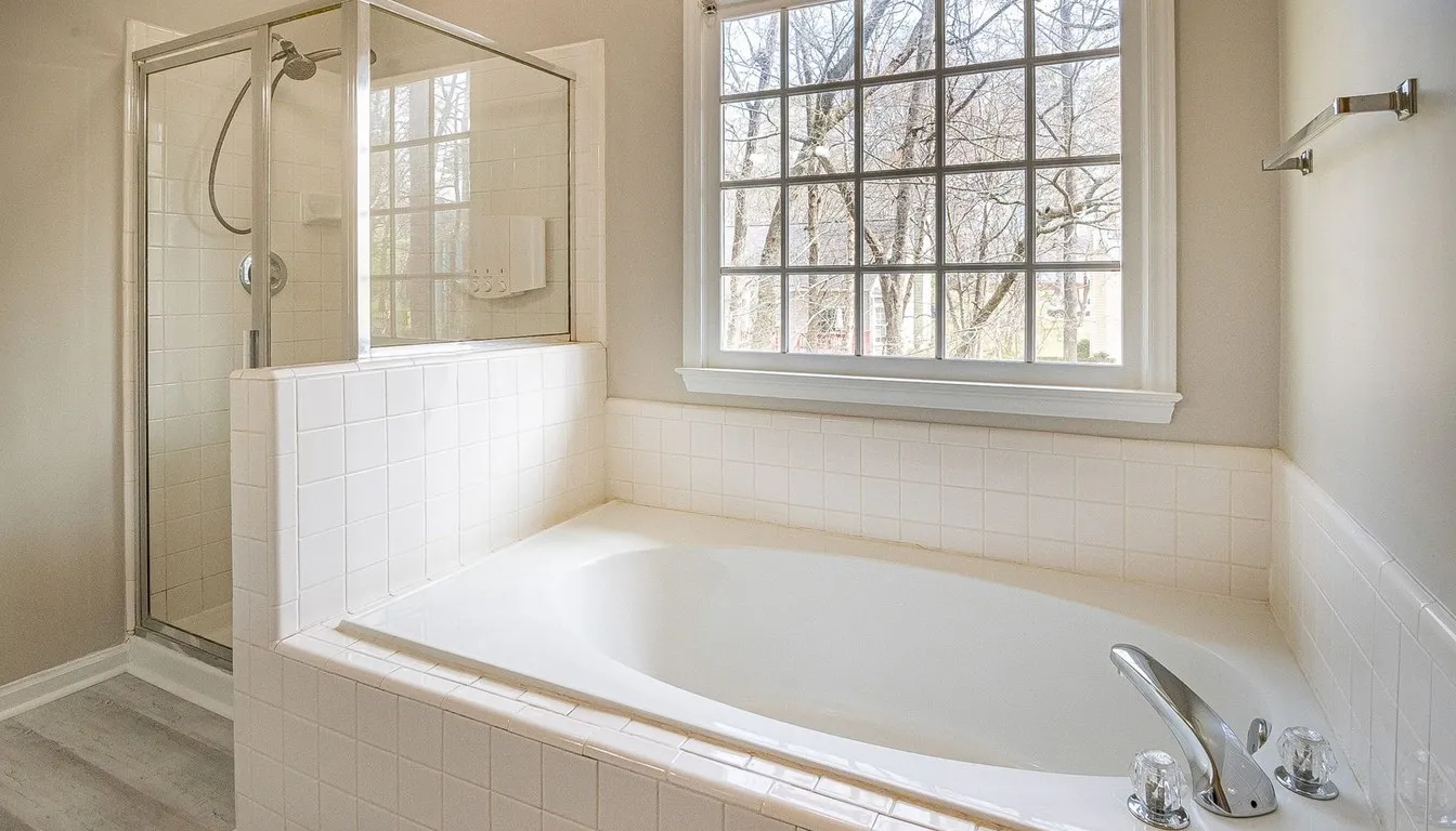 Bathroom with a glass shower enclosure and white tile