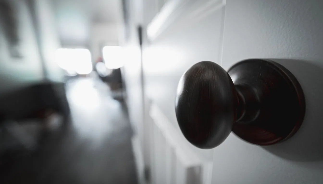 Close-up of a round door knob on a white door