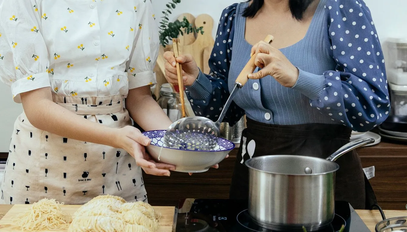 Cook holding a bowl over a saucepan on the stove