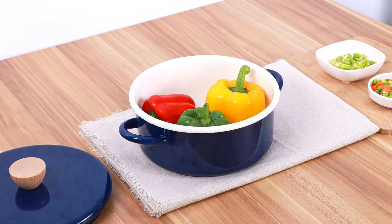 Blue enamelled pot holding peppers on a wooden table