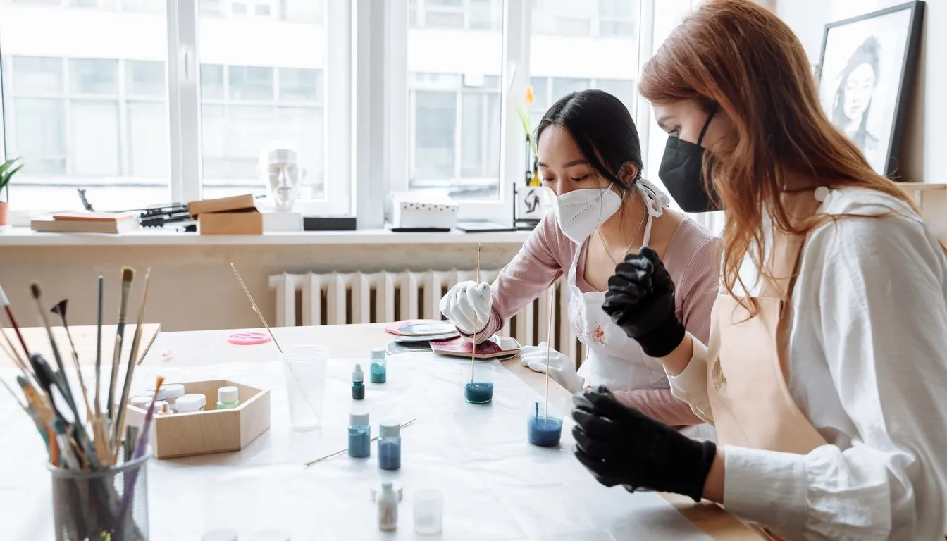Two people mixing epoxy resin at a craft table