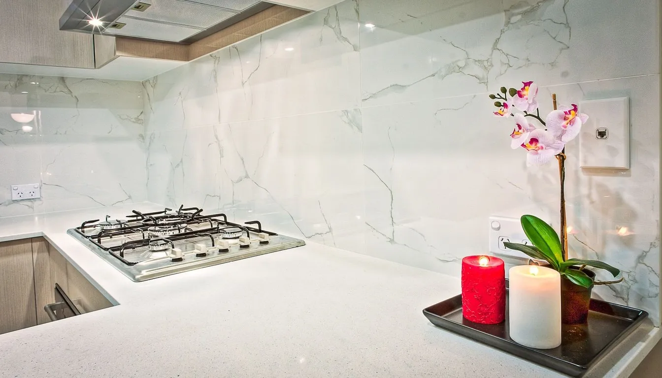 Glass cooktop set into a white kitchen counter
