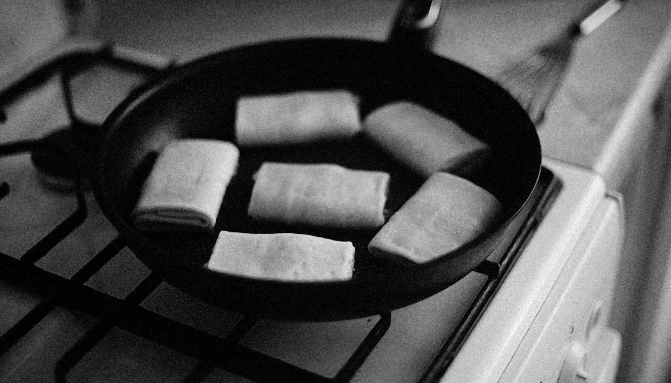 Dark skillet resting on a gas stove grate