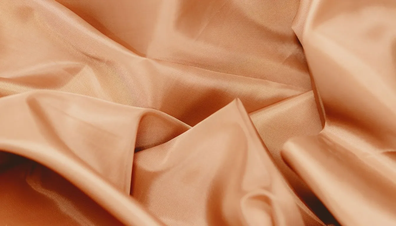 Draped peach-colored silky fabric