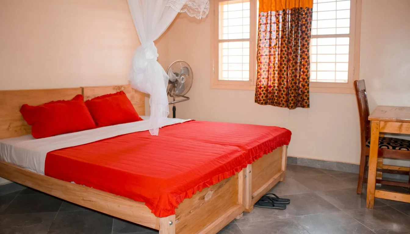 Bed draped with a white mosquito net