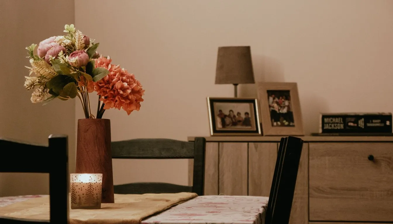 Dark wood dining furniture with framed photos and flowers