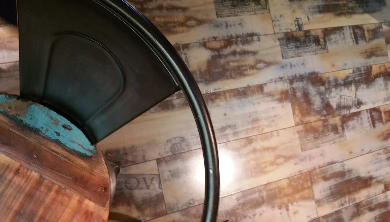 Weathered wooden floorboards with a cafe chair