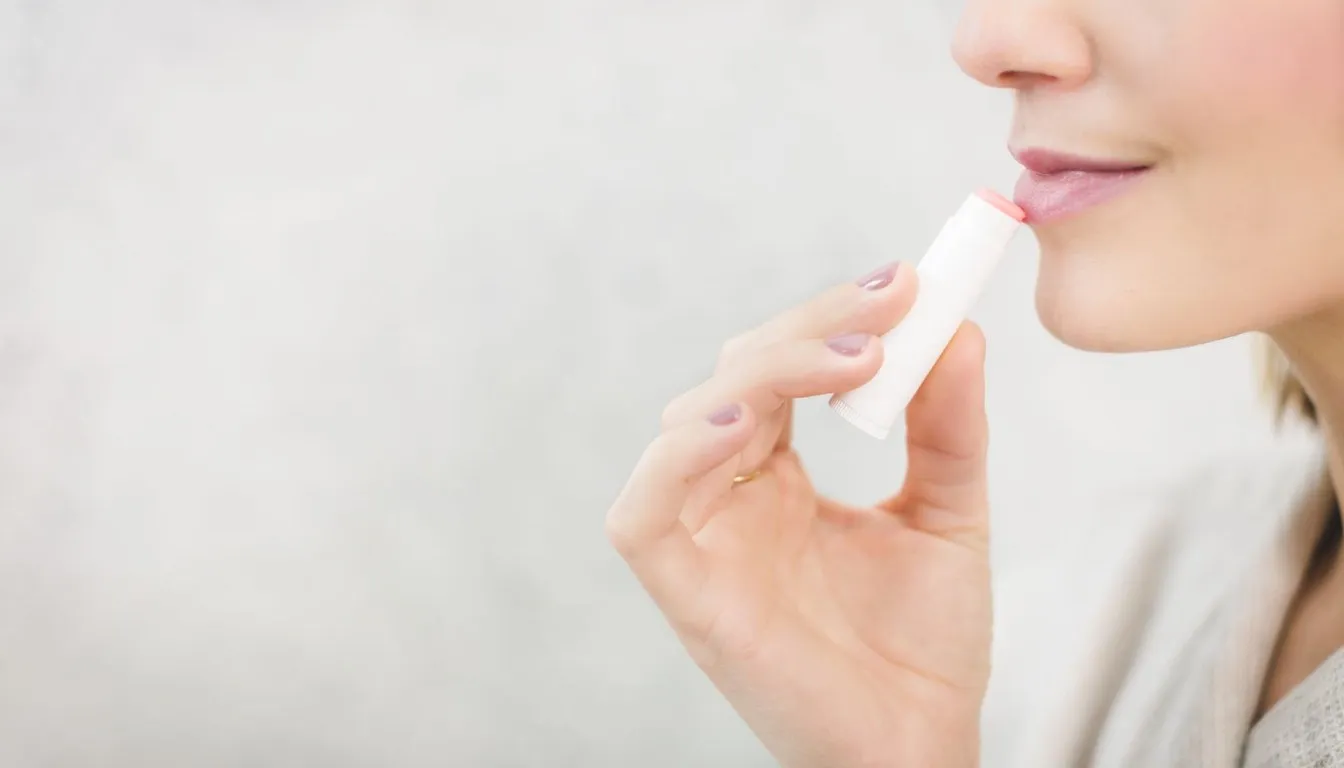 Woman applying lip balm