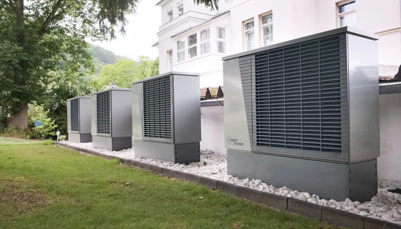 Heat pump units installed in a row outside a house