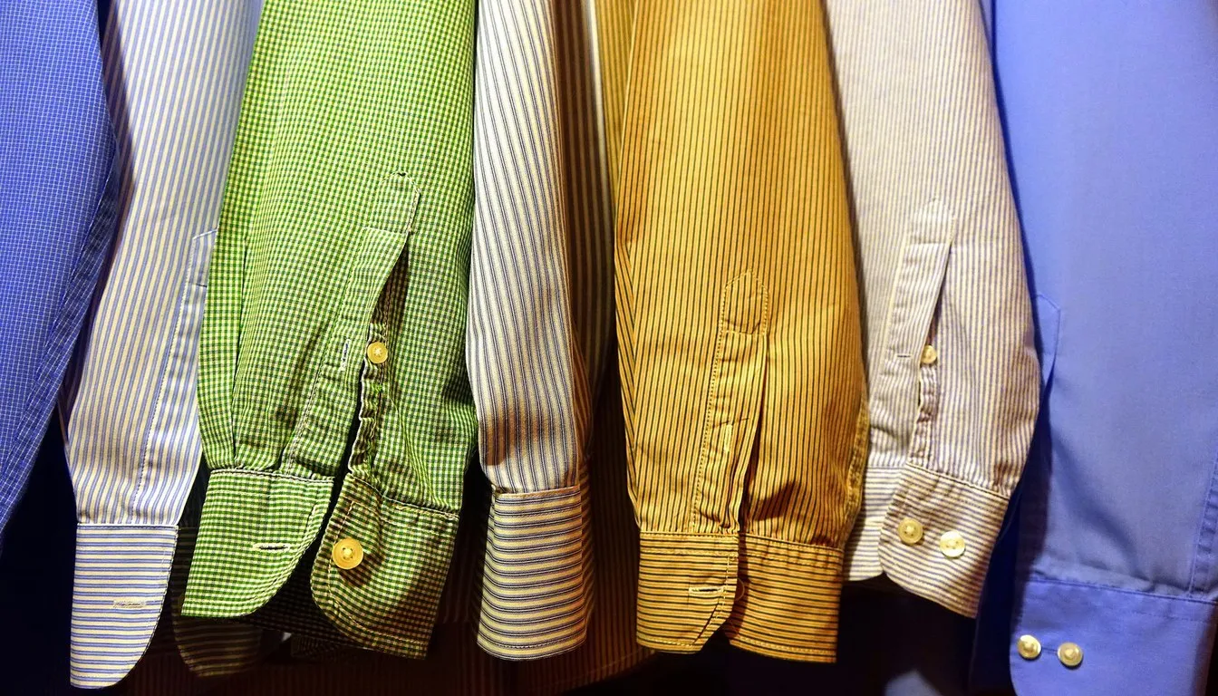 Colorful button-down shirts hanging in a row