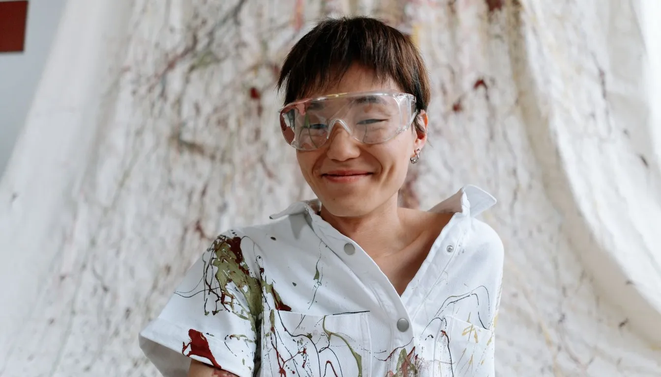 Smiling kid in a paint-splattered shirt
