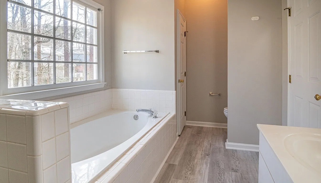 Bathtub and tiled surround in a bright bathroom