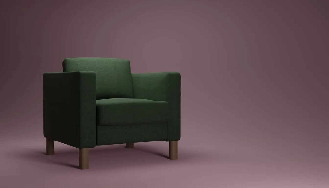 Green upholstered armchair against a pink background