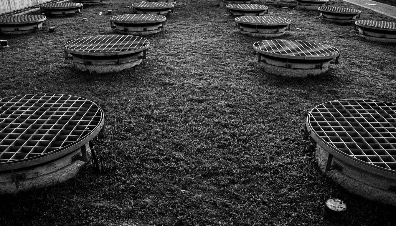 Field dotted with round septic covers and vents