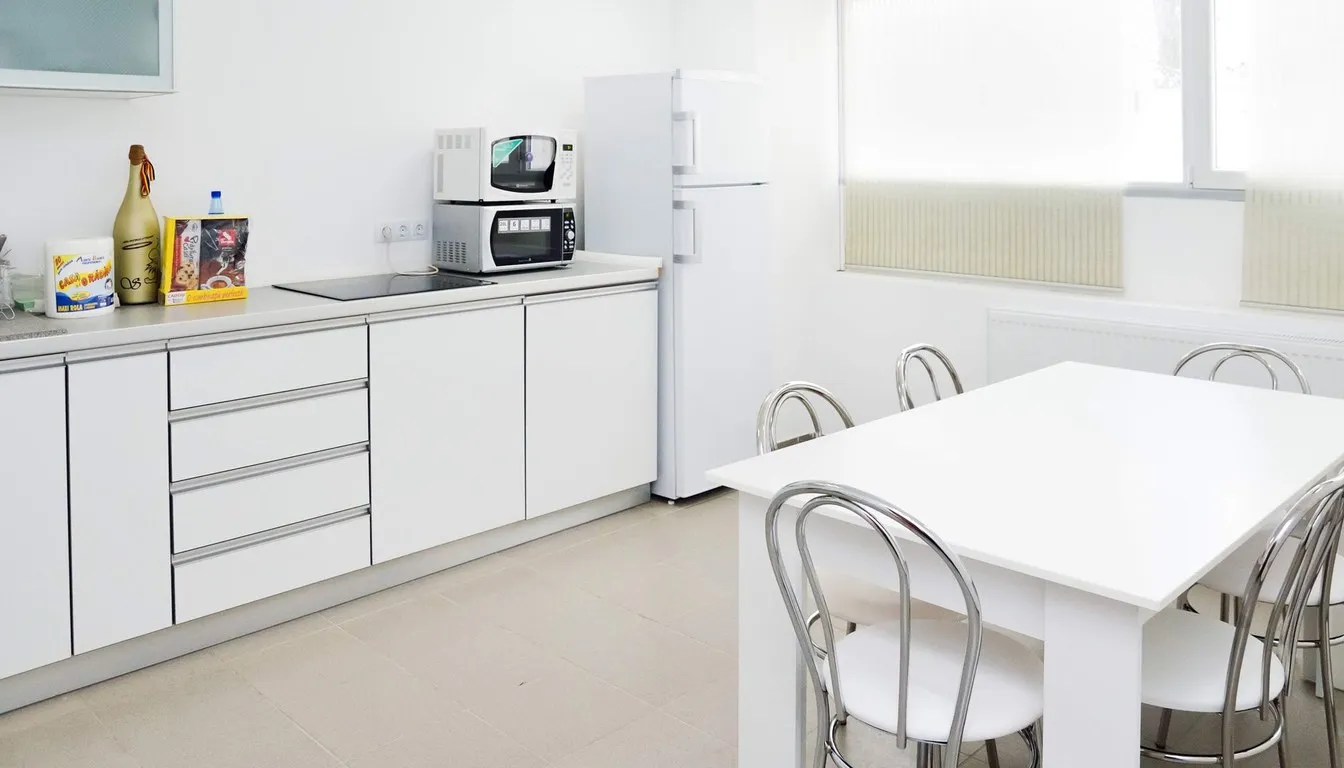 Compact kitchen with a small microwave on the counter