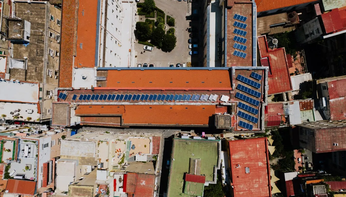 Aerial view of city rooftops fitted with solar panels