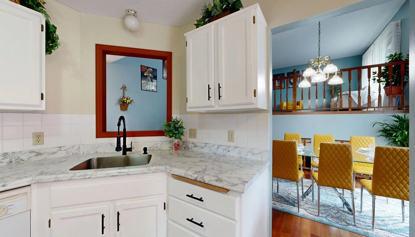 Kitchen with a light stone countertop and white cabinets