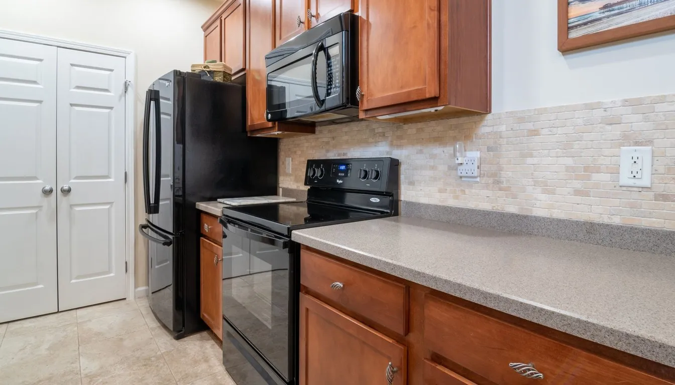 Kitchen with a black over-the-range microwave and oak cabinets