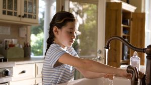 child using a sink installed by plumbers in omaha
